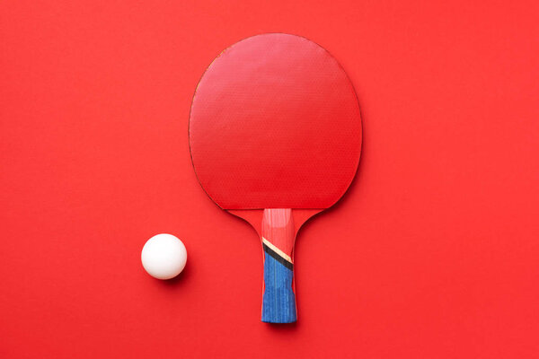 Table tennis rackets and white ball on green background with copy space. Top view. Flat lay. Sport concept