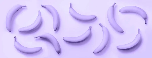 Chaotic colorful fruit pattern. Bananas over trendy violet color background. Banner. Top view. Pop art design, creative summer concept. Minimal flat lay style. — 스톡 사진