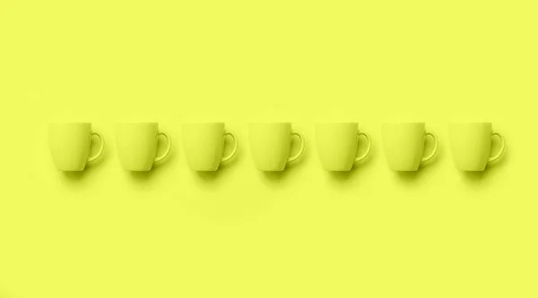 Row with cups over yellow neon background. Birthday party celebration, baby shower concept. Monochrome colors pattern. Banner. Minimalist style design — 스톡 사진