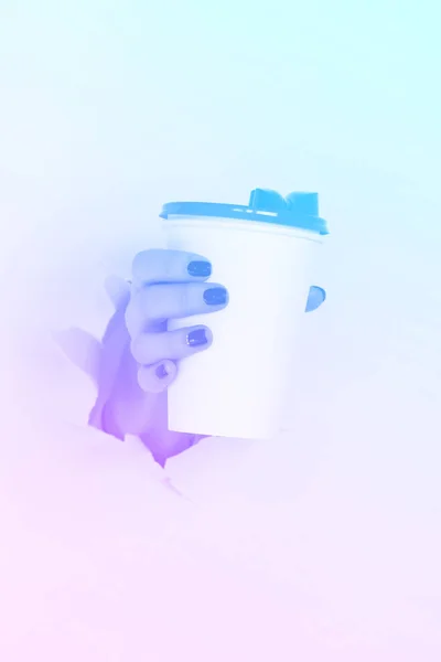 Tazza di carta bianca con mano femminile in colori neon alla moda. Sfondo gradiente arcobaleno con spazio di copia. Portare via il concetto di tazza di caffè. Fingere con spazio di copia — Foto Stock