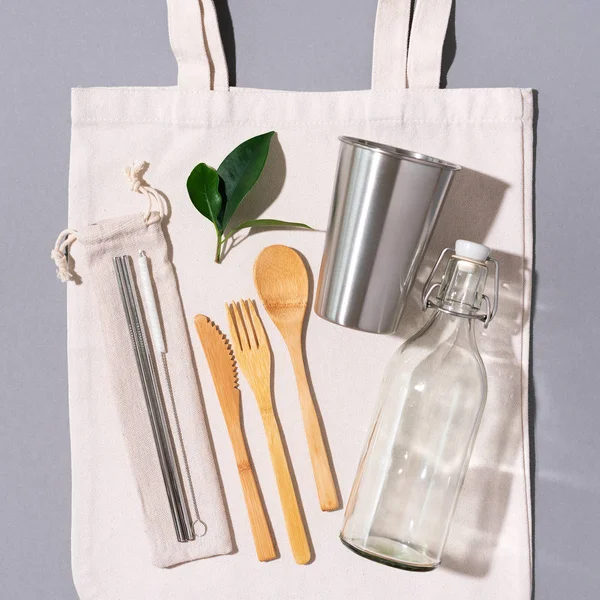 Fabric bags, glass jars, metal straws, bamboo cutlery on grey background with copy space. Eco friendly and reuse concept. Top view. Flat lay. Zero waste concept — Stock Photo, Image