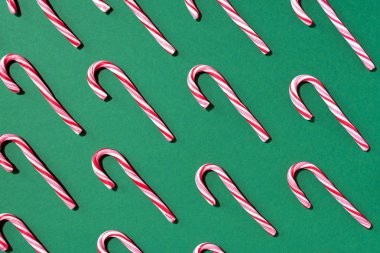 Yeşil arka planda noel şekeri deseni. Üst Manzara. Düz yatıyordu. Yaratıcı asgari konsept. Noel ve Yeni Yıl 'da tebrik kartı. Sanat bileşimi.