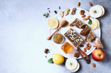Sonbahar hasat konsepti. Bal ve arı ürünleri seti, elma, limon, gri beton arka planda baharatlar. Alternatif tıpla bağışıklık sistemi desteği
