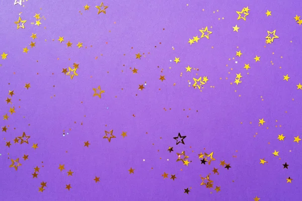 Estrela dourada brilha sobre fundo violeta. Conceito de Natal e Ano Novo. Cenário festivo com espaço de cópia — Fotografia de Stock
