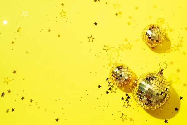 Creative Christmas concept. Shiny gold disco balls over green background.  Flat lay, top view. New year baubles, star sparkles. Party time. Greeting  card Stock Photo by ©j.chizhe 309319534