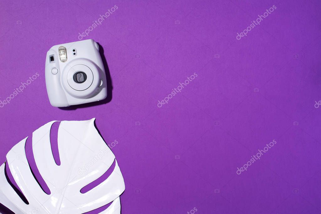 Vilnius, Lithuania - September 16, 2019: FUJIFILM INSTAX Mini Instant Film Camera on violet background.
