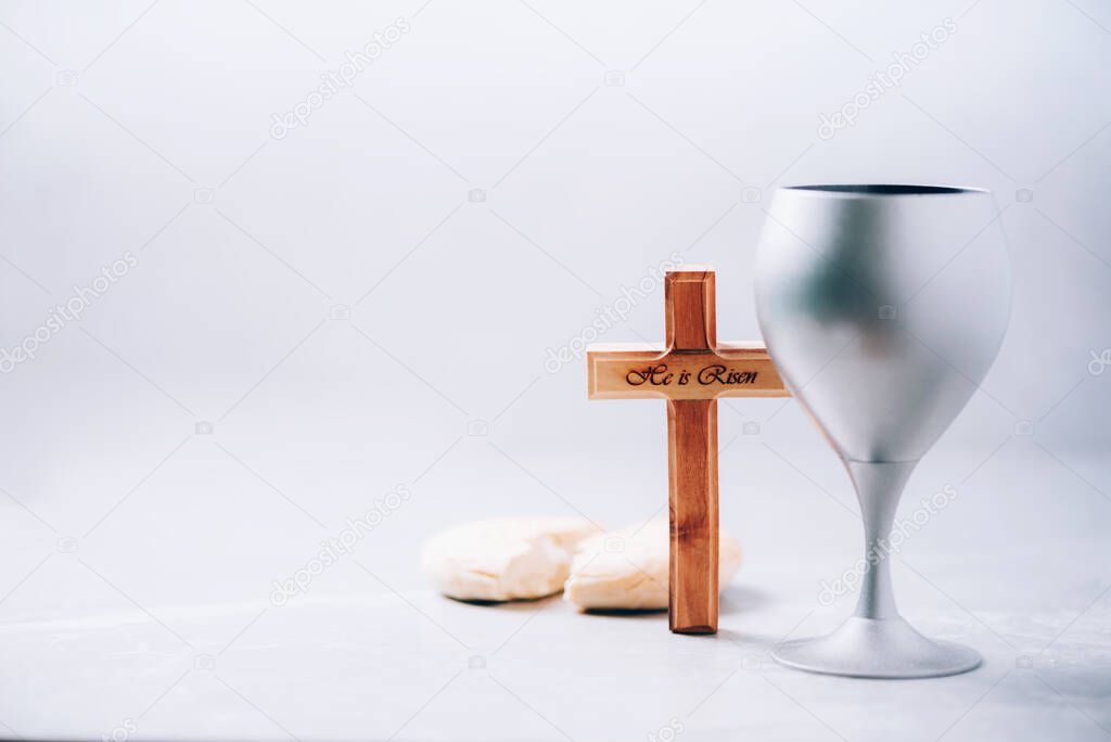 Communion still life. Unleavened bread, chalice of wine on grey background. Christian communion concept for reminder of Jesus sacrifice. Easter passover.