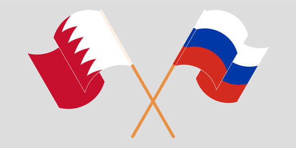 Crossed and waving flags of Bahrain and Russia