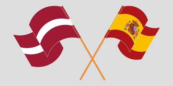 Lettország és Spanyolország keresztezett és lengő lobogói — Stock Vector