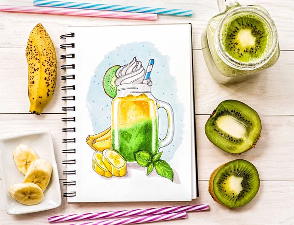 a bright milkshake sketch made with markers decorated with fruit slices on white wooden background. a hand-drawn illustration wth milkshake in mason jar ina sketchbook decorated with a milkshake cocktail, kiwis,bananas and drinking straws on white wo