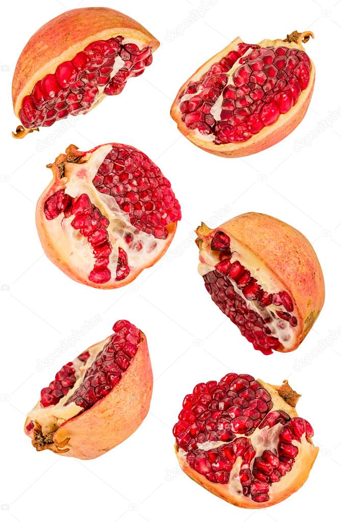 creative fruit concept. pomegranates halves flying in the air isolated on white with clipping path. levity concept fruit