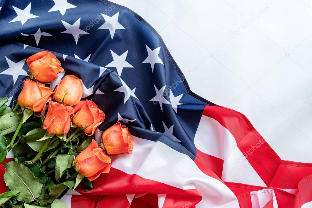 Roses over the USA flag flat lay top view. Independence Day