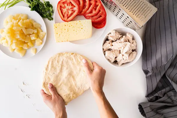 Жіночі руки готують тісто для піци на білому столі вид зверху квартира лежала — стокове фото