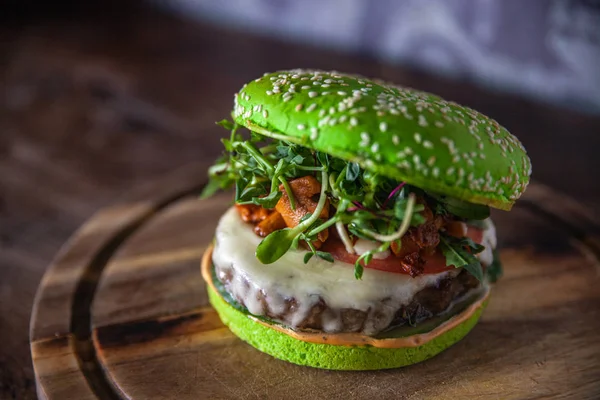 green burger with meat, cheese and mushrooms