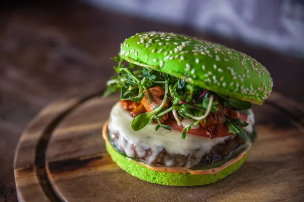 green burger with meat, cheese and mushrooms