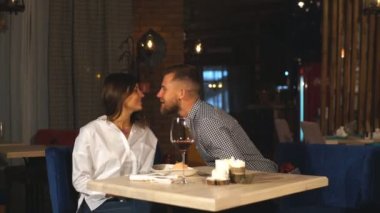 Genç adam kafede genç bir kıza hediye veriyor.