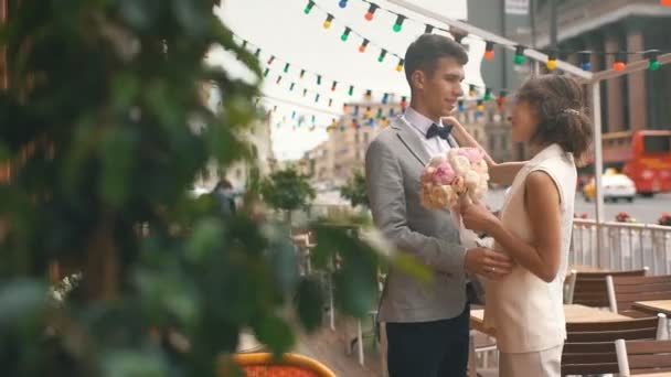 Recién casados abrazándose en la terraza de verano del restaurante — Vídeos de Stock