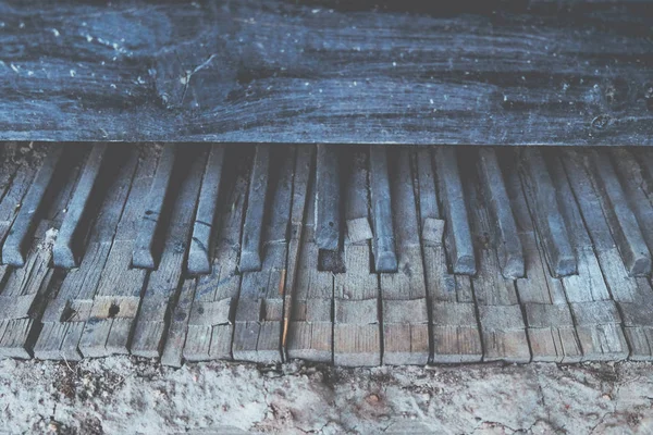 Old vintage broken piano keyboard background toned