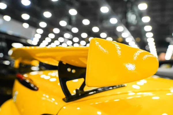 Yellow racing spoiler on the car Close-up. The concept of a sports car.