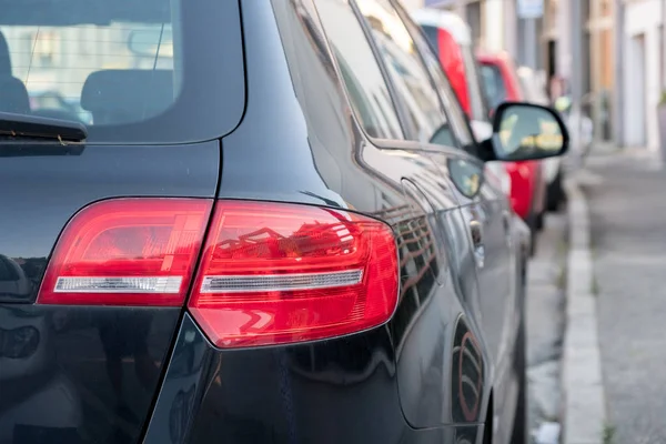 Yaz aylarında siyah arabanın arka kırmızı far. Stop lambası yakın çekim