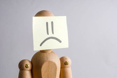 Mutsuz bir insan yüzü kavramı. Yüzünde hüzün görüntüsü ile bir etiket ile ahşap Vitrin mankeni.