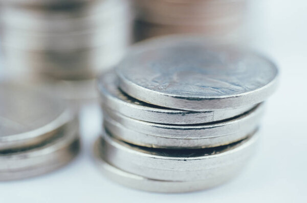 Stacks of coins on a white background. Close up.