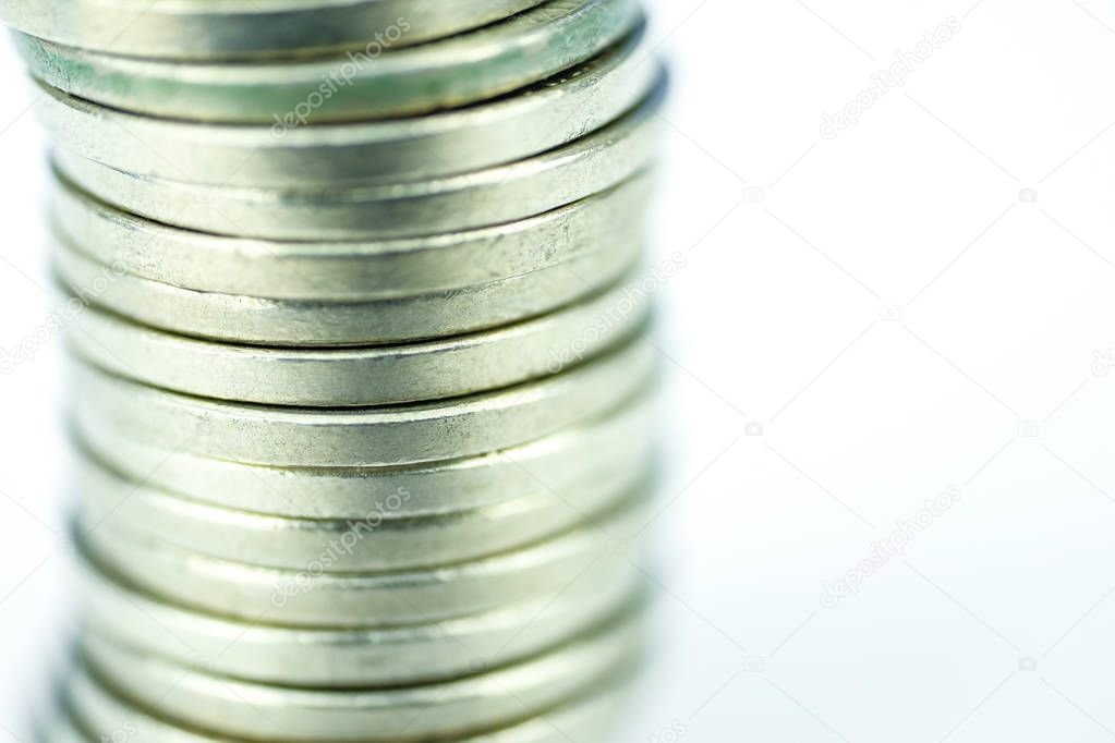 Stack of coins on a white background. Close up.