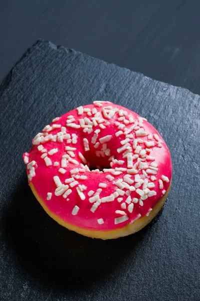 Şist yemekleri üzerinde sırlı pembe donut. — Stok fotoğraf