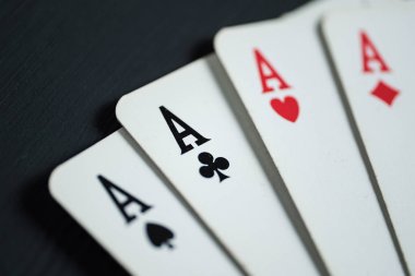 Siyah ahşap arka plan üzerinde yalan dört as.