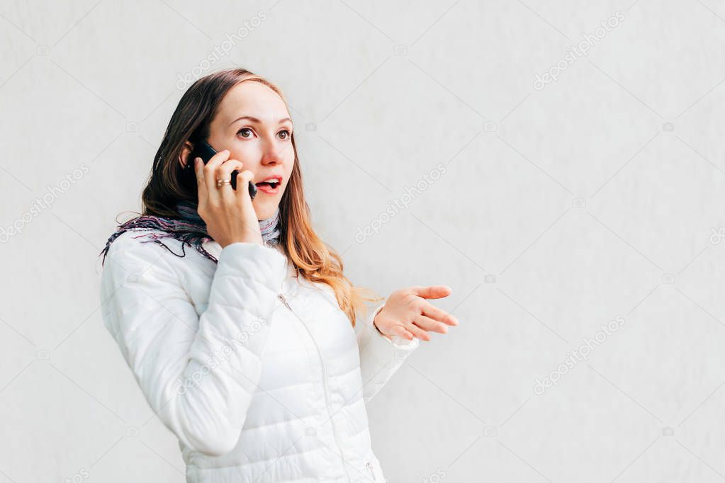 Portrait headshot of young Caucasian woman enthusiastically gesticulate arguing on mobile phone.