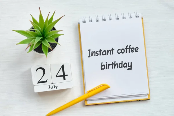 24th july month calendar on wooden blocks - Instant coffee birthday holiday concept.