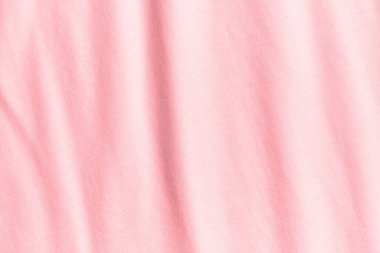 Buruşmuş pastel pembe kumaşın dokusu ve arka planı.