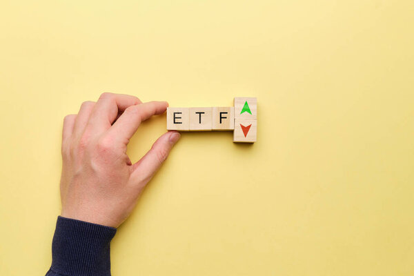ETF concept with up and down arrows on yellow background