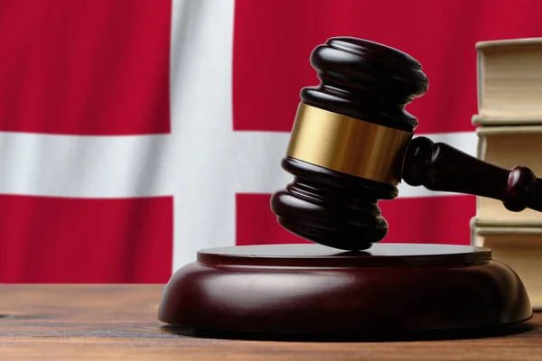 Justice and court concept in Kingdom of Denmark. Judge hammer on a flag background.