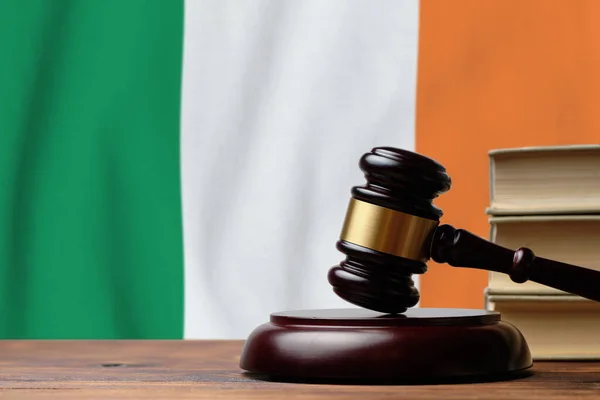 Justice and court concept in Ireland. Judge hammer on a flag background.