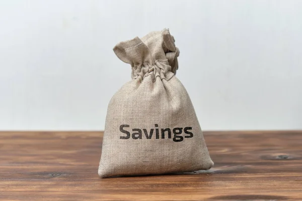 Money savings concept in a cloth bag.