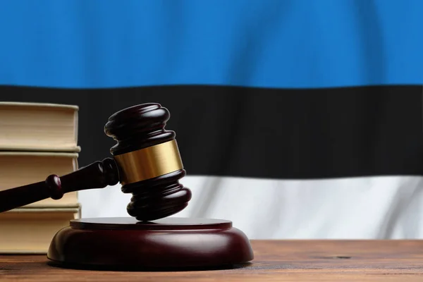 Justice and court concept in Republic of Estonia. Judge hammer on a flag background.