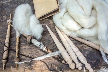 Tools for spinning wool and white sheep's wool.  Rural environment, rustic life. clipart