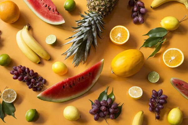 Fresh fruit on yellow background