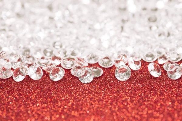 Silver pearls on red glitter light background