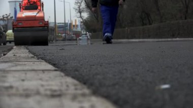 İşçilerin sıcak asfalt bir sokak yol inşaat işçileri ile kürek koruyucu üniformalı koyarsın. Sıcak günde çalışma.