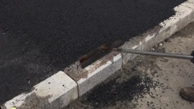 İşçilerin sıcak asfalt bir sokak yol inşaat işçileri ile kürek koruyucu üniformalı koyarsın. Sıcak günde çalışma.