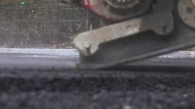 İşçilerin sıcak asfalt bir sokak yol inşaat işçileri ile kürek koruyucu üniformalı koyarsın. Sıcak günde çalışma.