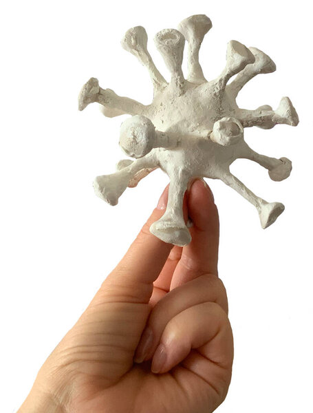 Hand presentation of a clay model of a bacterial virus, coronavirus, covid-19, isolated on white background, clipping path