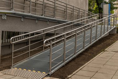 Engelliler için erişilebilir rampa, bebek arabaları ve engelliler için raylı metal rampa, kamu binasının mimari erişilebilirliği