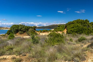 Kum tepeleri, kaya oluşumları ve Hırvatistan 'ın Rab adasındaki Ciganka doğabilimci plajına giden yol.