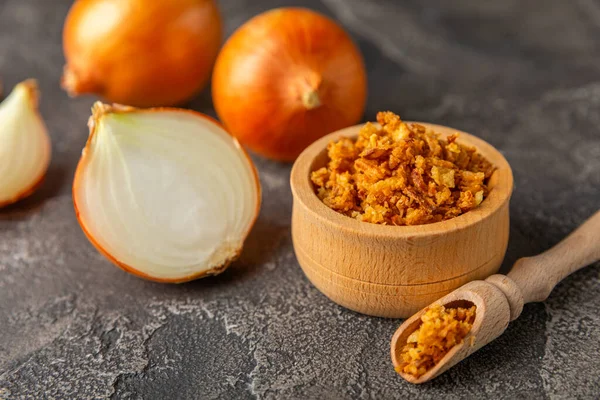 Tahta bir masada kasede kızarmış soğan. Kızarmış soğan. Bulaşık çeşnisi. Baharatlar. Salata sosu. Mesaj için yer var. Boşluğu kopyala