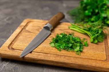 Doku masasında Dill ve Maydanoz. Maydanozla dereotu karıştırdım. Taze aromalı baharatlı sebzeler. Baharatlar ve bitkiler. Mesaj için yer var. Boşluğu kopyala