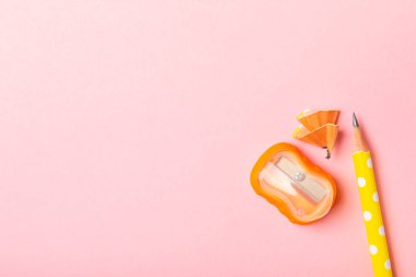 Renkli arka planda kalem açacağı. Kalem ve kalem talaşı. Kırtasiye malzemeleri. Okul malzemeleri. Okul ürünleri. Düz yatıyordu. Mesaj için yer. Boşluğu kopyala.