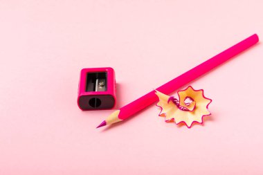 Renkli arka planda kalem açacağı. Kalem ve kalem talaşı. Kırtasiye malzemeleri. Okul malzemeleri. Okul ürünleri. Düz yatıyordu. Mesaj için yer. Boşluğu kopyala.